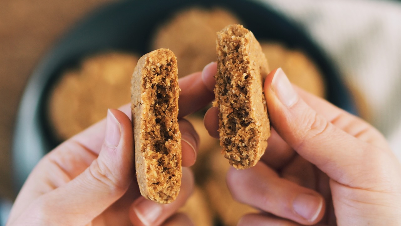 Peanut Butter Cookie hold in hands, showing the chewy middle